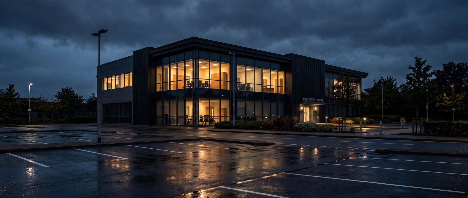 Business park car park at night, one unit with the lights on